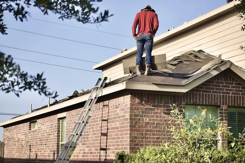 Professional roofer working on a residential roof in Celebration